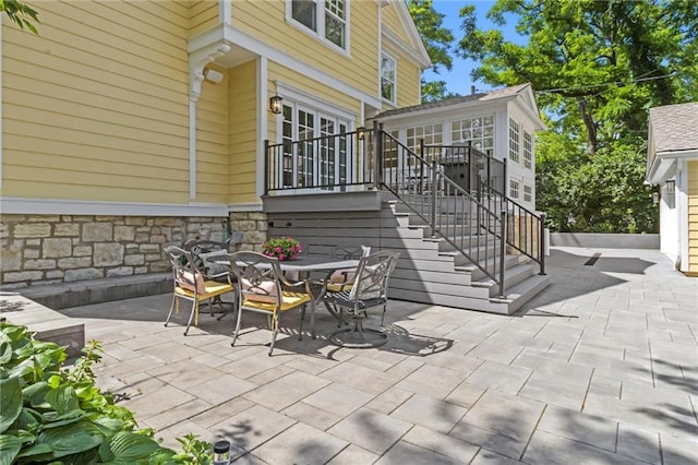 4525 Kenwood Ave, Kansas City, MO 64110 - view of patio / terrace with stairs and outdoor dining area