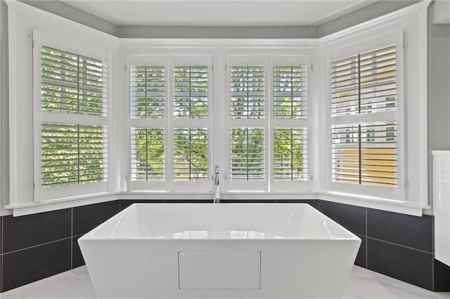 4525 Kenwood Ave, Kansas City, MO 64110 - full bath featuring a wealth of natural light, a freestanding bath, and marble finish floor