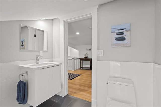 4525 Kenwood Ave, Kansas City, MO 64110 - bathroom with tile patterned floors, toilet, vanity, and visible vents