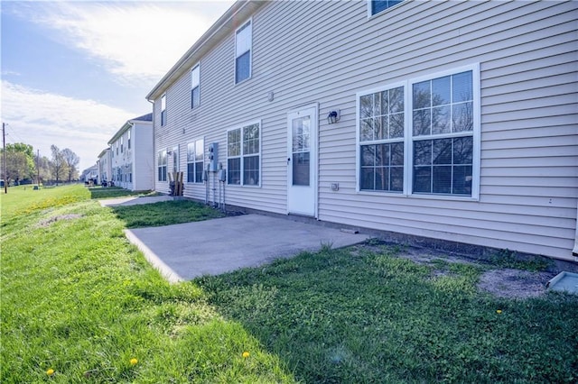 back of property featuring a yard and a patio area