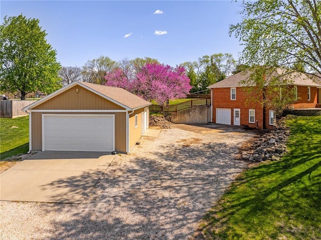 9015 Craig Dr, De Soto, KS 66018 - ranch-style home featuring a detached garage, brick siding, and an outbuilding