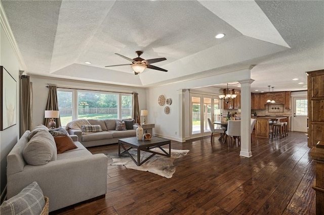 9015 Craig Dr, De Soto, KS 66018 - living room featuring a tray ceiling, a textured ceiling, ornate columns, a ceiling fan, and plenty of natural light