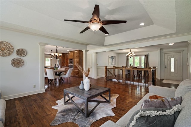 9015 Craig Dr, De Soto, KS 66018 - living room featuring a chandelier, ornate columns, a tray ceiling, plenty of natural light, and recessed lighting