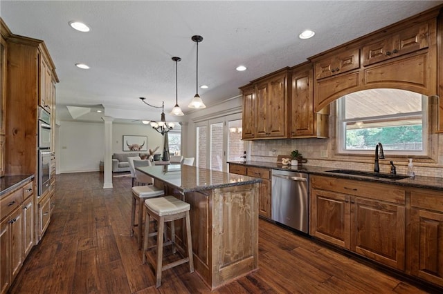 9015 Craig Dr, De Soto, KS 66018 - kitchen with appliances with stainless steel finishes, a sink, open floor plan, dark wood-style flooring, and recessed lighting