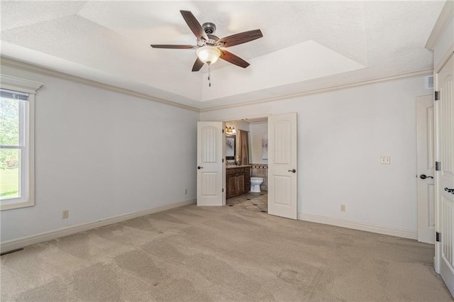 9015 Craig Dr, De Soto, KS 66018 - unfurnished bedroom with light carpet, a raised ceiling, baseboards, ensuite bath, and ornamental molding