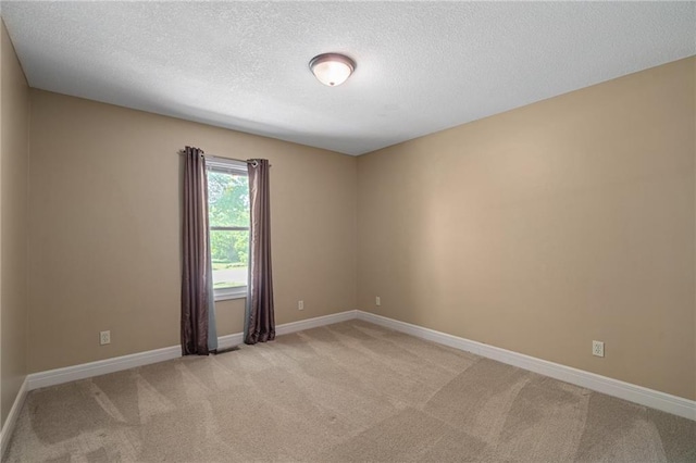 9015 Craig Dr, De Soto, KS 66018 - empty room with light colored carpet, a textured ceiling, and baseboards