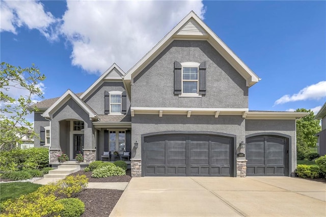 craftsman house featuring driveway, stucco siding, stone siding, and an attached garage