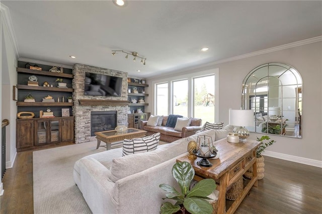 living room with recessed lighting, dark wood finished floors, crown molding, baseboards, and a stone fireplace
