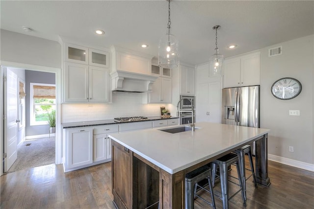 kitchen with baseboards, visible vents, appliances with stainless steel finishes, and dark wood-style floors