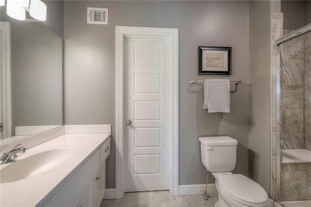full bathroom featuring toilet, a stall shower, visible vents, baseboards, and vanity