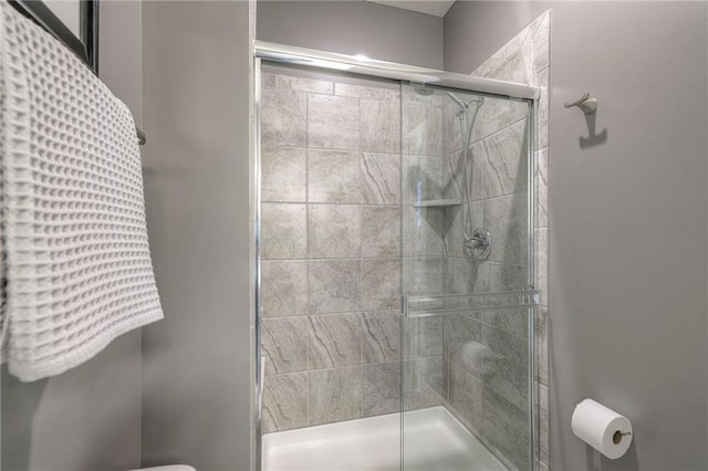 full bathroom with toilet and a shower stall