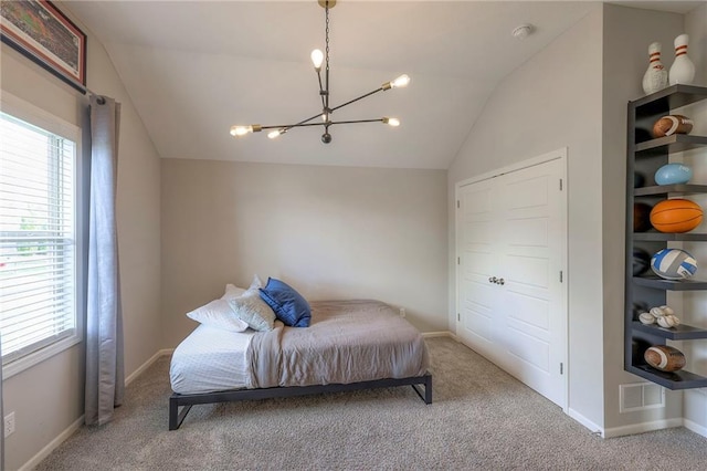 carpeted bedroom featuring baseboards, multiple windows, a notable chandelier, and vaulted ceiling