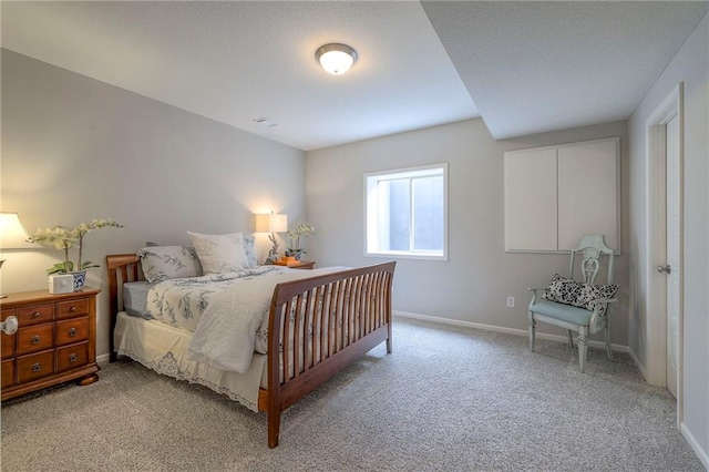 bedroom featuring light colored carpet and baseboards