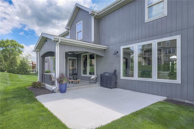 back of property with a yard, a patio, and ceiling fan
