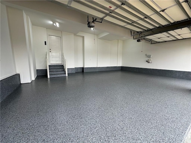 garage featuring baseboards and a garage door opener