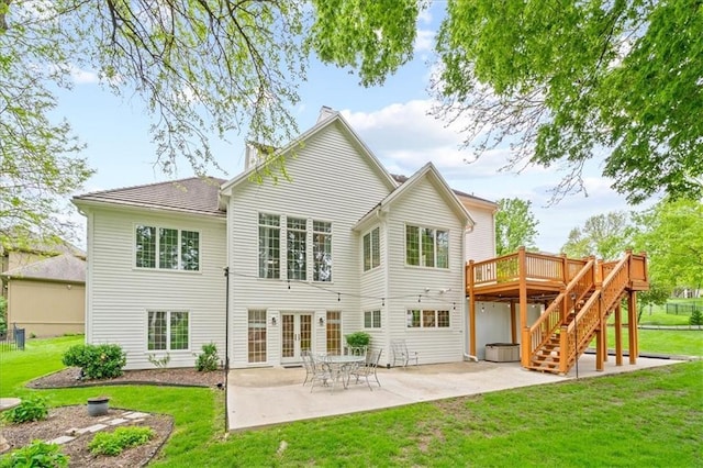 back of house with a wooden deck, french doors, stairs, a patio area, and a lawn