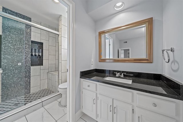 bathroom featuring toilet, a shower stall, marble finish floor, and vanity