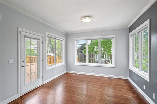 interior space featuring visible vents, dark wood finished floors, crown molding, and baseboards