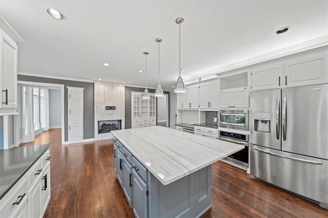 kitchen with stainless steel appliances, open shelves, gray cabinetry, and white cabinetry
