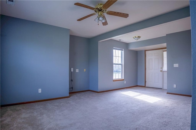 empty room with ceiling fan, carpet flooring, and baseboards