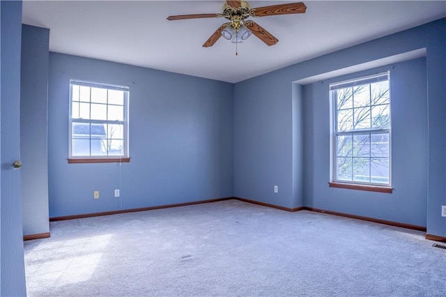 unfurnished room with plenty of natural light, carpet flooring, and baseboards