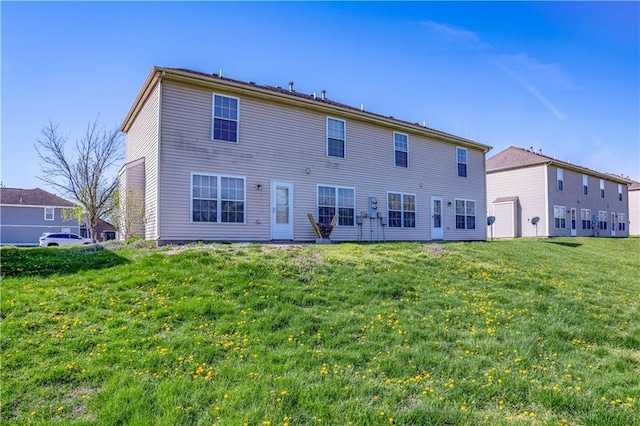 back of house with a lawn