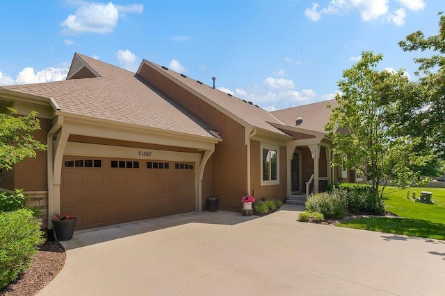 21287 W 116th St, Olathe, KS 66061 - ranch-style home featuring an attached garage, driveway, stucco siding, a front lawn, and roof with shingles