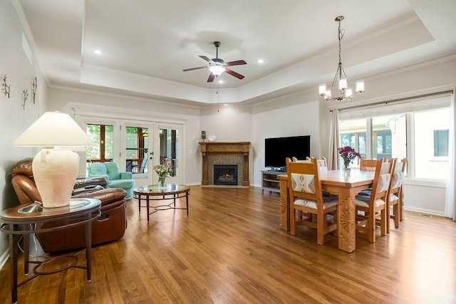 21287 W 116th St, Olathe, KS 66061 - dining area featuring a tray ceiling, wood finished floors, ceiling fan, plenty of natural light, and crown molding