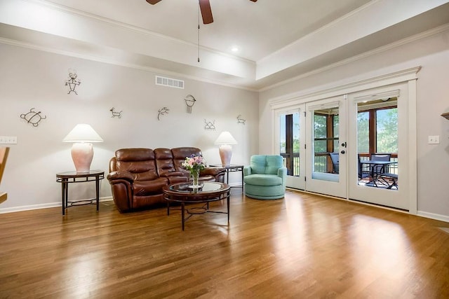 21287 W 116th St, Olathe, KS 66061 - living area with french doors, ceiling fan, wood finished floors, a tray ceiling, and crown molding