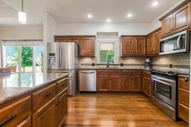 21287 W 116th St, Olathe, KS 66061 - kitchen featuring stainless steel appliances, a sink, dark stone countertops, dark wood-style flooring, and backsplash
