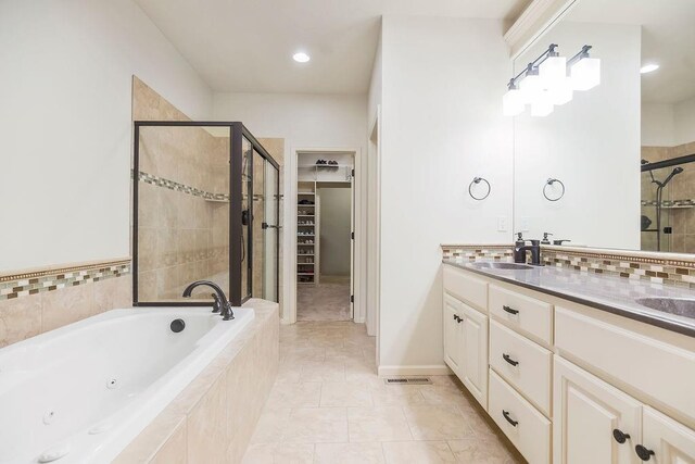 21287 W 116th St, Olathe, KS 66061 - bathroom with a stall shower, a whirlpool tub, double vanity, a spacious closet, and tile patterned flooring