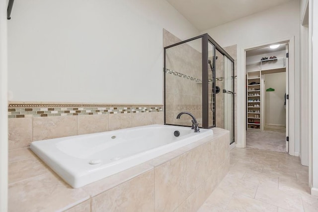 21287 W 116th St, Olathe, KS 66061 - full bathroom featuring a spacious closet, a shower stall, and a garden tub