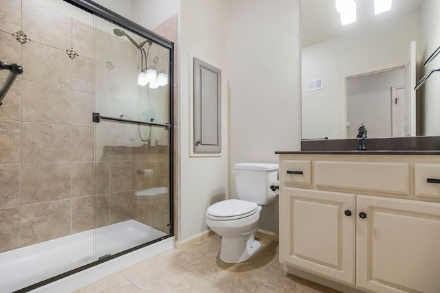 21287 W 116th St, Olathe, KS 66061 - bathroom featuring a shower stall, toilet, vanity, baseboards, and tile patterned floors