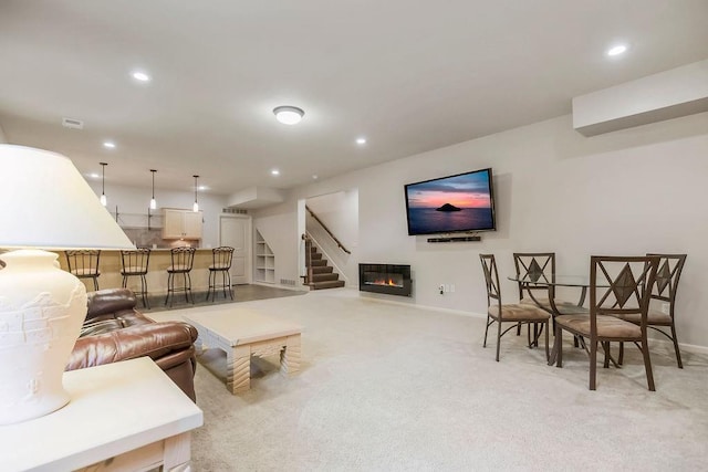 21287 W 116th St, Olathe, KS 66061 - living room with light colored carpet, recessed lighting, baseboards, stairs, and a glass covered fireplace