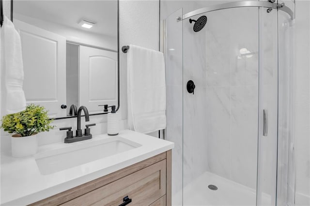 full bath with a shower stall and vanity