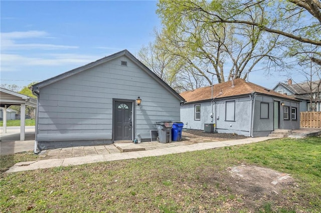 back of house featuring a yard, fence, and central AC unit