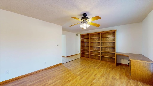 spare room with visible vents, ceiling fan, baseboards, and light wood-type flooring