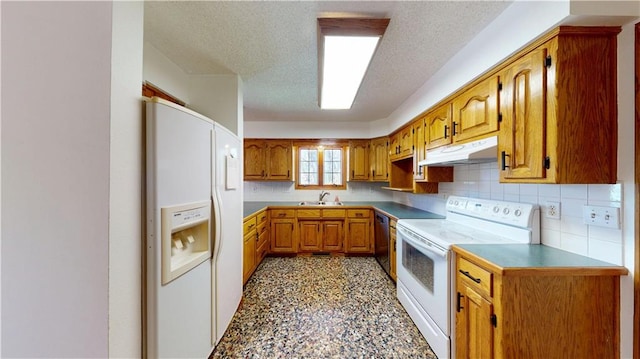 kitchen with under cabinet range hood, a sink, white appliances, brown cabinetry, and a textured ceiling