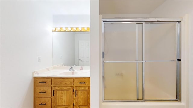 bathroom with a shower with door and vanity