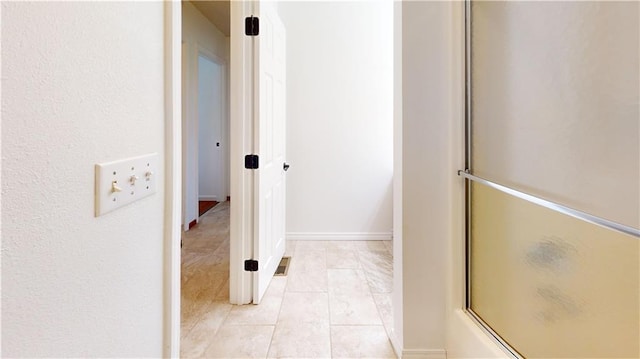 corridor featuring visible vents and light tile patterned floors