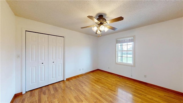 unfurnished bedroom featuring light wood-style floors, visible vents, and baseboards