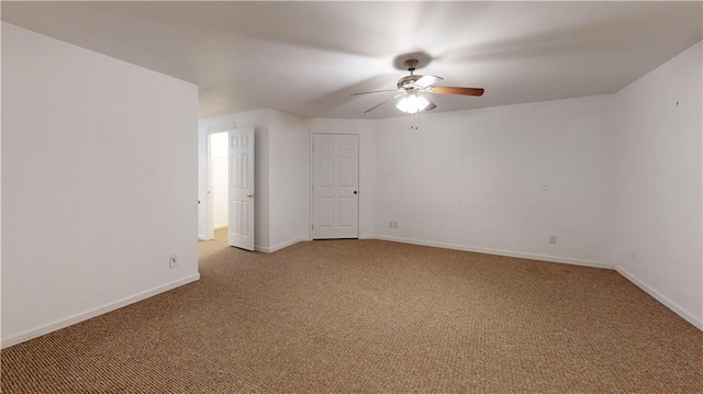 carpeted empty room with baseboards and ceiling fan