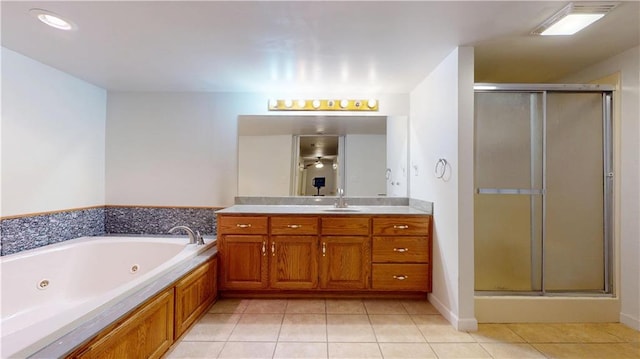 full bathroom featuring tile patterned floors, vanity, a shower stall, and a jetted tub