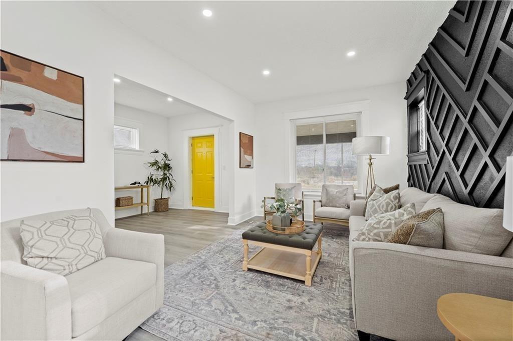 3232 Woodland Ave, Kansas City, MO 64109 - living area with baseboards, recessed lighting, and wood finished floors