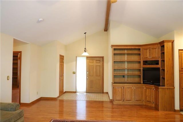 1203 E Quincy St, Pittsburg, KS 66762 - unfurnished living room featuring baseboards, beam ceiling, light wood-style floors, and high vaulted ceiling