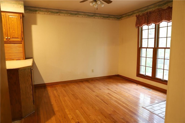 1203 E Quincy St, Pittsburg, KS 66762 - unfurnished room with baseboards, a ceiling fan, visible vents, and light wood-style flooring