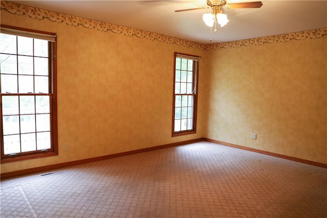 1203 E Quincy St, Pittsburg, KS 66762 - carpeted spare room with ceiling fan, baseboards, and visible vents