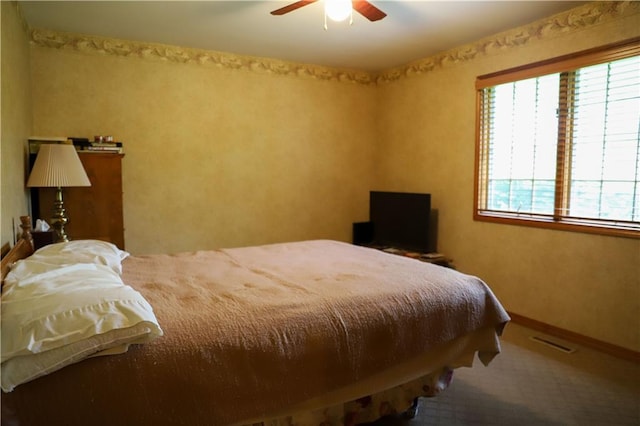 1203 E Quincy St, Pittsburg, KS 66762 - carpeted bedroom featuring baseboards, a ceiling fan, multiple windows, and visible vents
