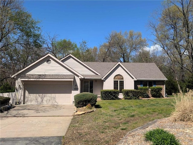 1203 E Quincy St, Pittsburg, KS 66762 - ranch-style house featuring an attached garage, driveway, and a front yard