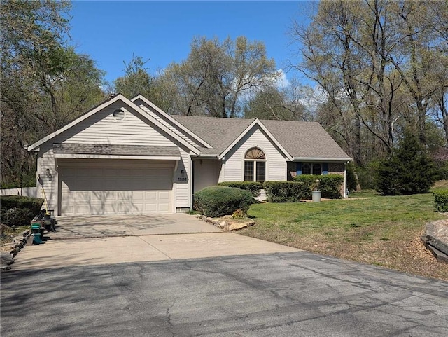 1203 E Quincy St, Pittsburg, KS 66762 - single story home featuring an attached garage, driveway, and a front yard
